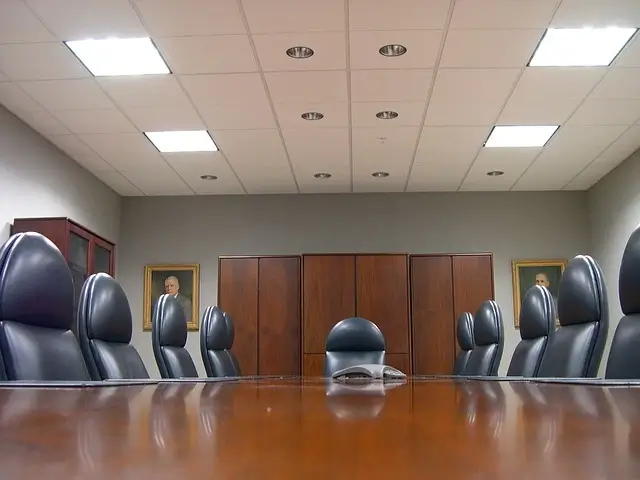 Empty Board Room - Several Chairs sitting around a long board table