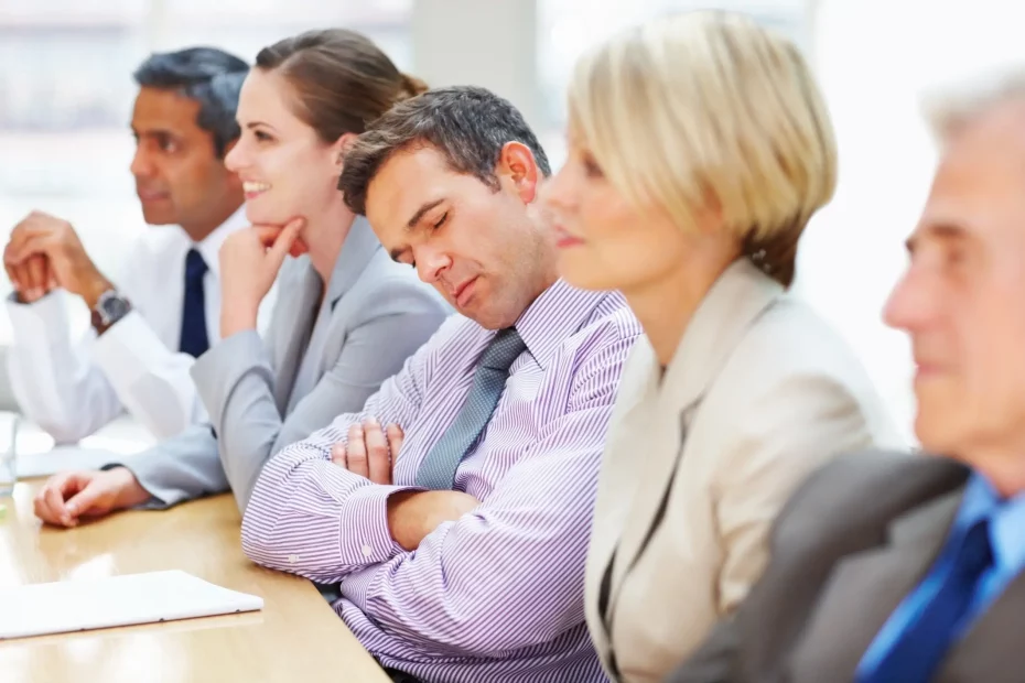 Man sleeping at a board meeting